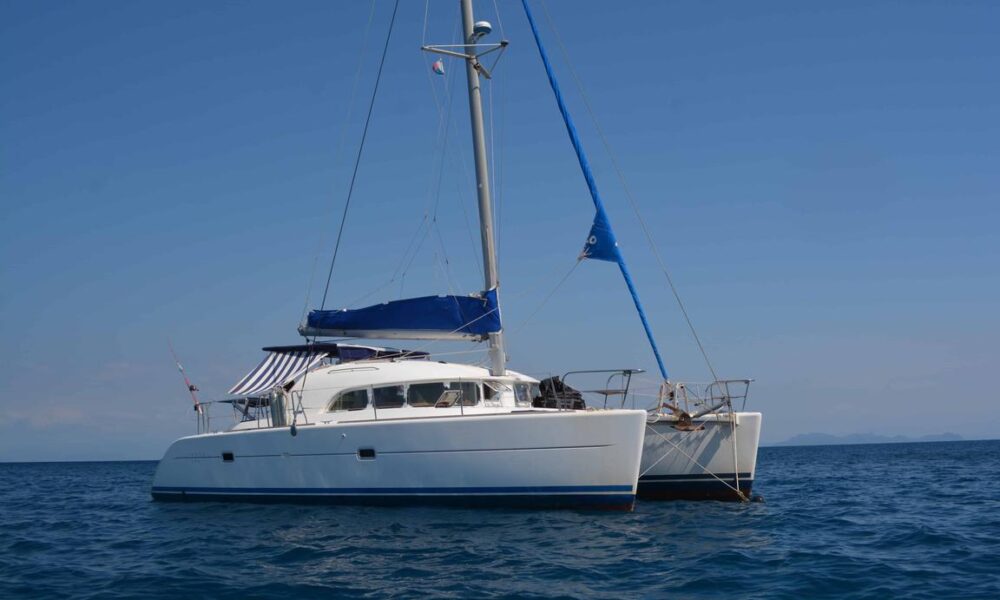 Catamaran Lagoon 380 with crew in le cratère marina, Nosy Be, Madagascar